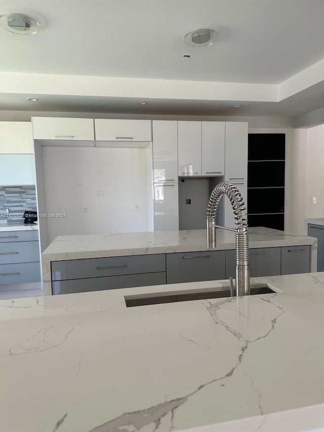 kitchen with white cabinets and light stone countertops