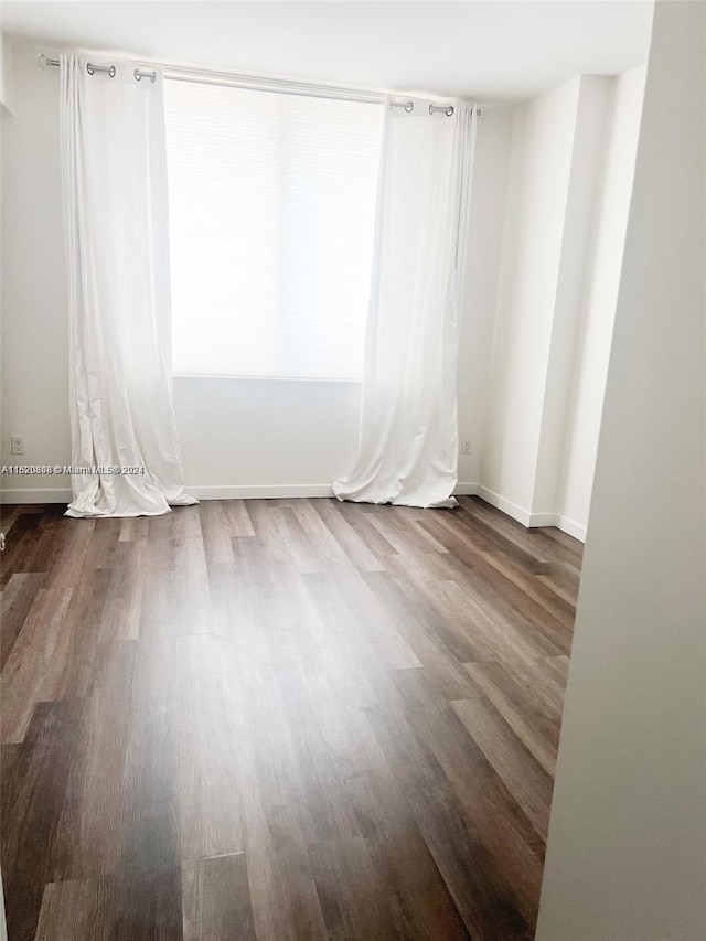 unfurnished room with hardwood / wood-style floors