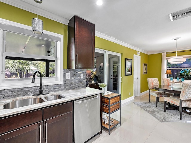 kitchen featuring light tile patterned flooring, tasteful backsplash, stainless steel dishwasher, pendant lighting, and sink