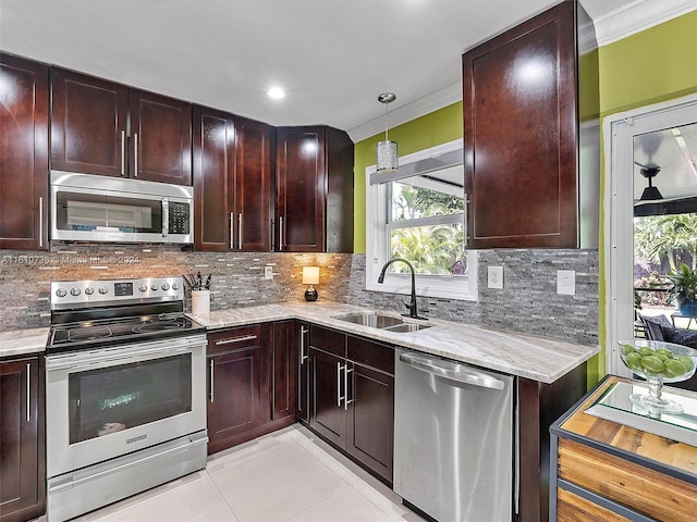 kitchen with appliances with stainless steel finishes, backsplash, decorative light fixtures, and sink