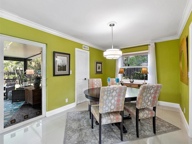 dining space featuring tile patterned flooring and ornamental molding