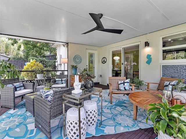 sunroom featuring ceiling fan