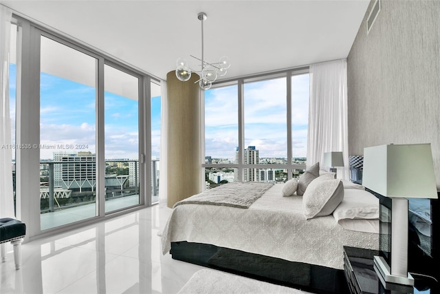 bedroom with multiple windows, floor to ceiling windows, access to exterior, and a chandelier