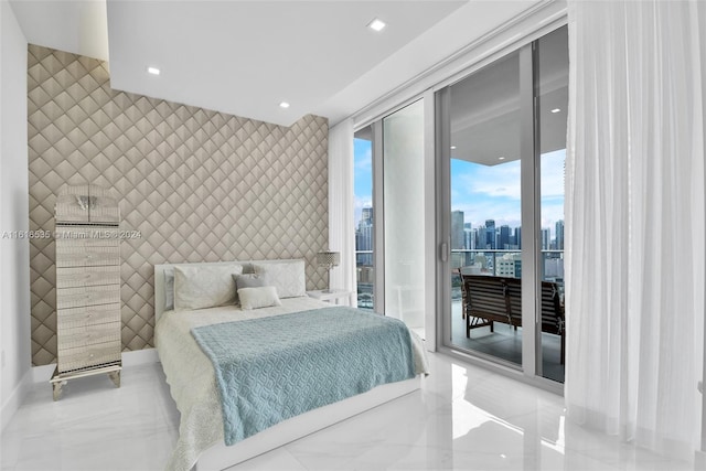 bedroom with expansive windows and access to exterior