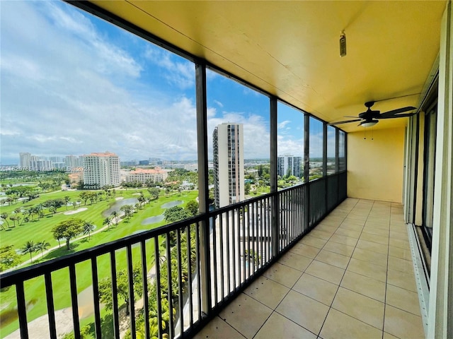 unfurnished sunroom featuring ceiling fan