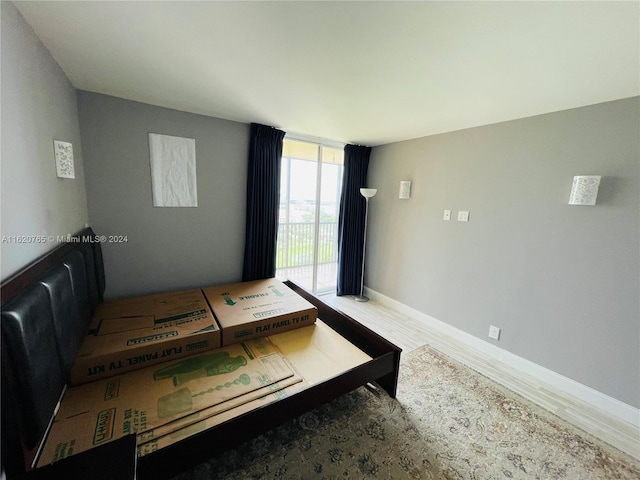 bedroom featuring access to outside and hardwood / wood-style flooring