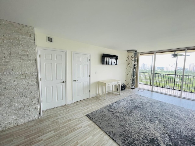 living room with ceiling fan and light wood-type flooring