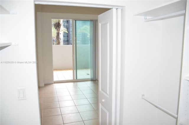 hall featuring light tile patterned flooring