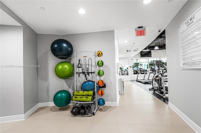 exercise room featuring tile patterned floors, baseboards, and recessed lighting