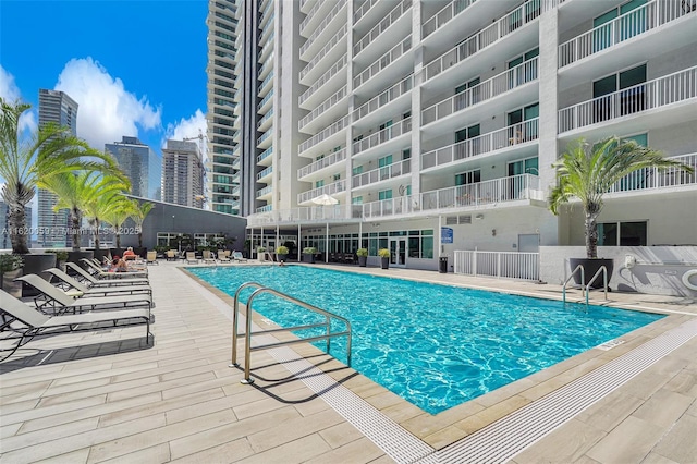 community pool featuring a patio area and a city view