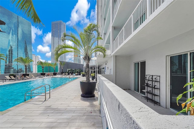 pool featuring a city view and a patio