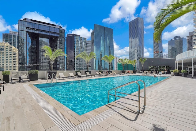 pool with a city view and a patio