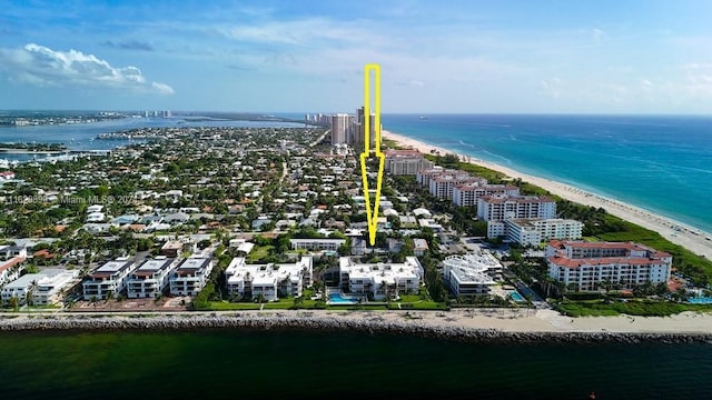 birds eye view of property featuring a beach view and a water view