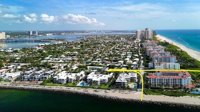 bird's eye view with a water view and a beach view