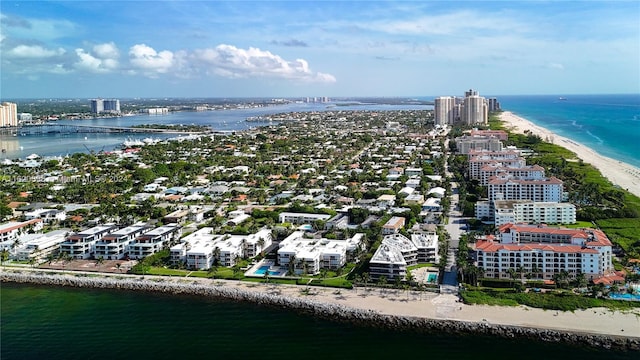 birds eye view of property featuring a water view and a beach view