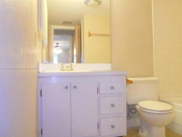 bathroom featuring toilet and vanity