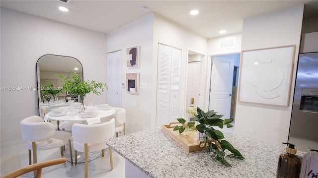 kitchen featuring light stone counters and stainless steel built in refrigerator