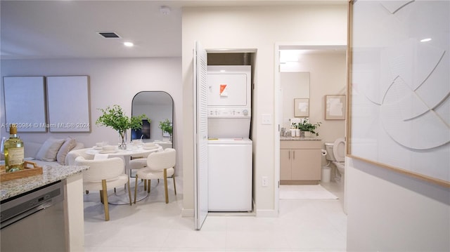 interior space featuring stacked washer and clothes dryer