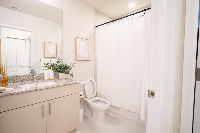 bathroom featuring tile patterned flooring, vanity, toilet, and curtained shower