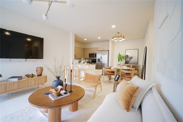 living room with an inviting chandelier and sink