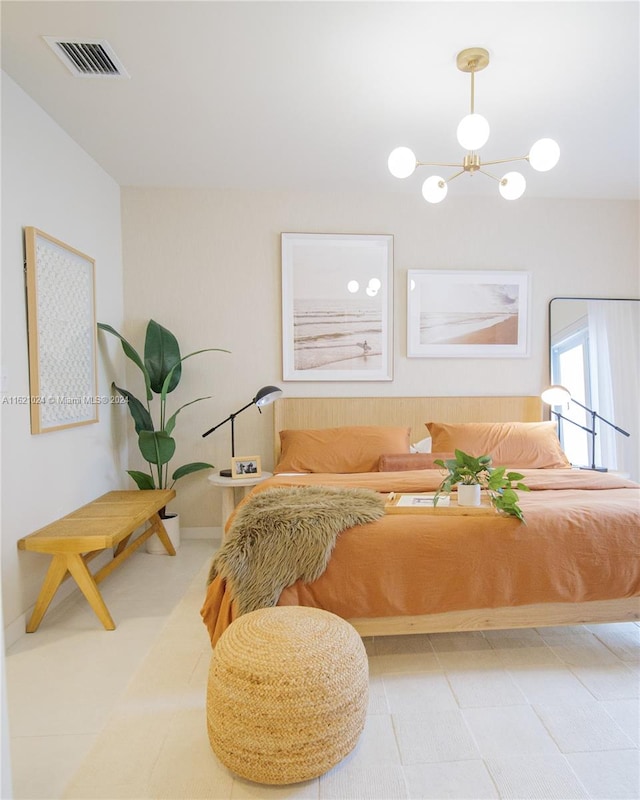 bedroom featuring an inviting chandelier