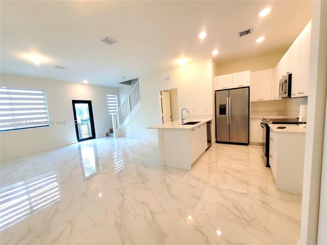 kitchen featuring white cabinetry, appliances with stainless steel finishes, and sink