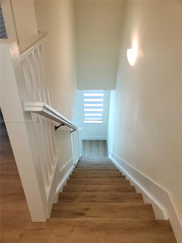 stairs with hardwood / wood-style floors