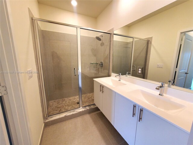 bathroom featuring an enclosed shower, vanity, and tile patterned floors