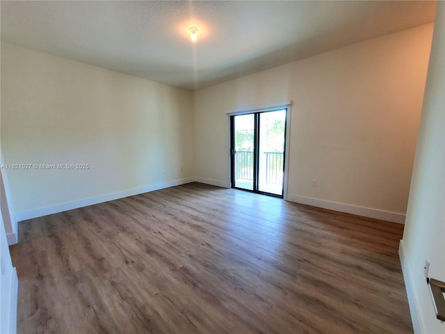 unfurnished room featuring hardwood / wood-style flooring