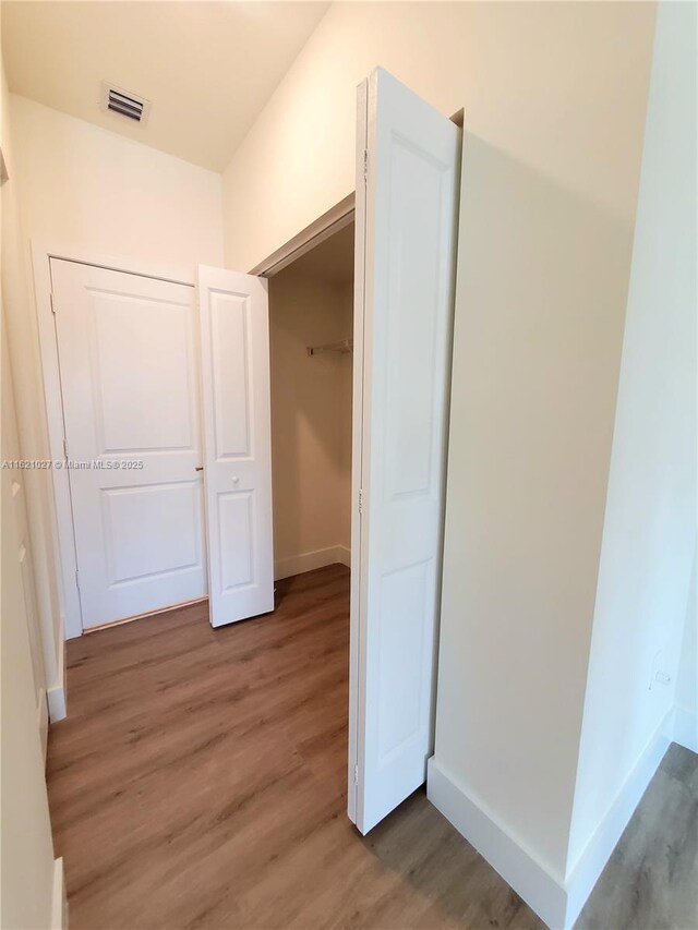 hallway featuring wood-type flooring