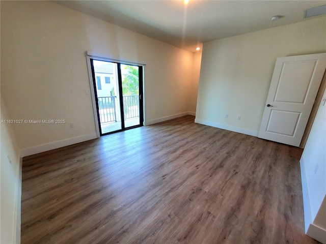 spare room with hardwood / wood-style floors