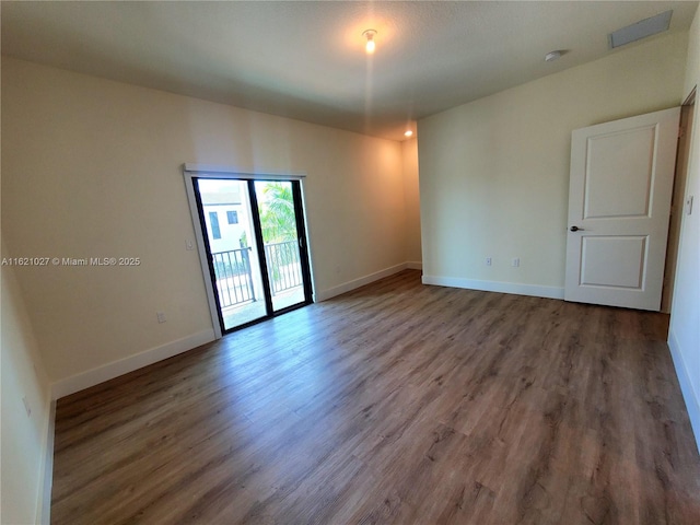 spare room with dark wood-type flooring