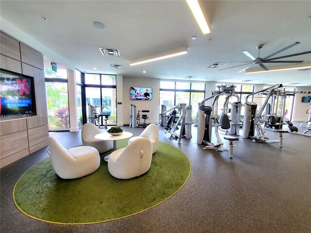 exercise room with floor to ceiling windows