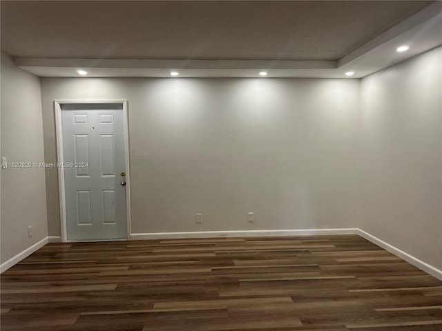 spare room featuring baseboards, dark wood-style flooring, and recessed lighting