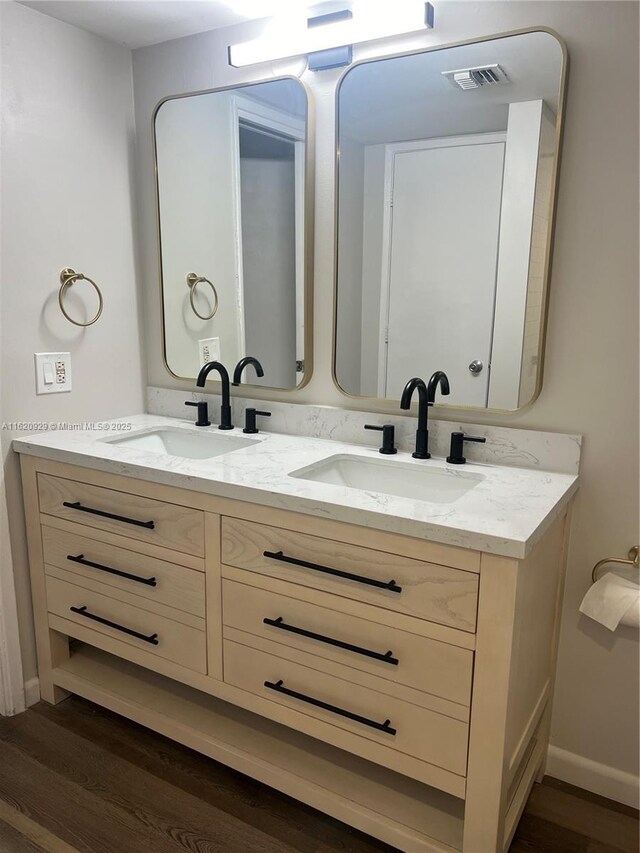 bathroom with hardwood / wood-style flooring, vanity, and toilet