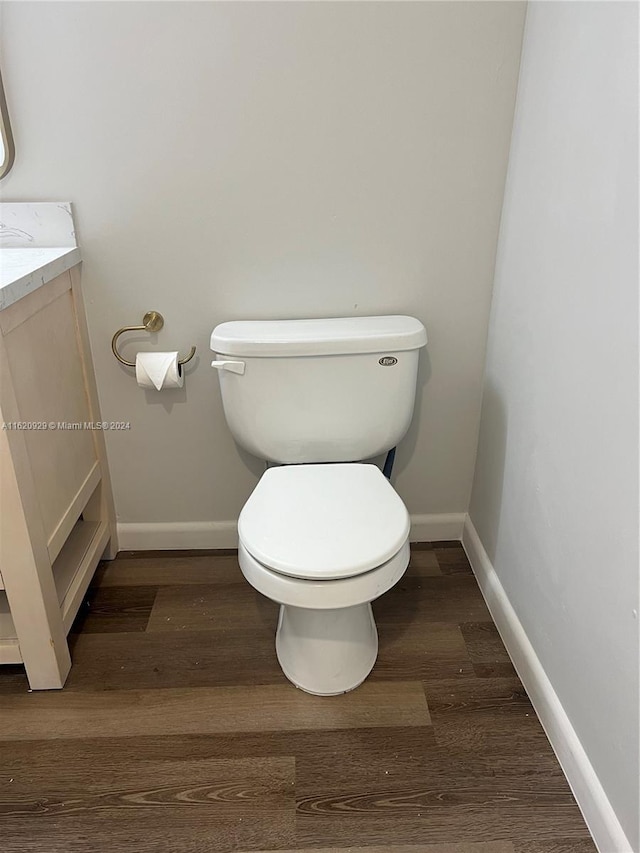 bathroom featuring toilet, baseboards, and wood finished floors