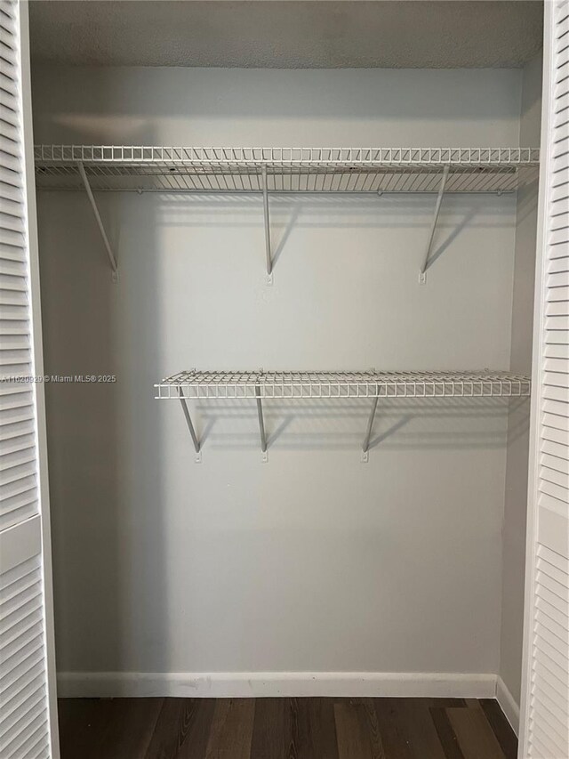 unfurnished bedroom featuring a closet and hardwood / wood-style flooring