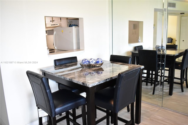 dining space with light wood-type flooring