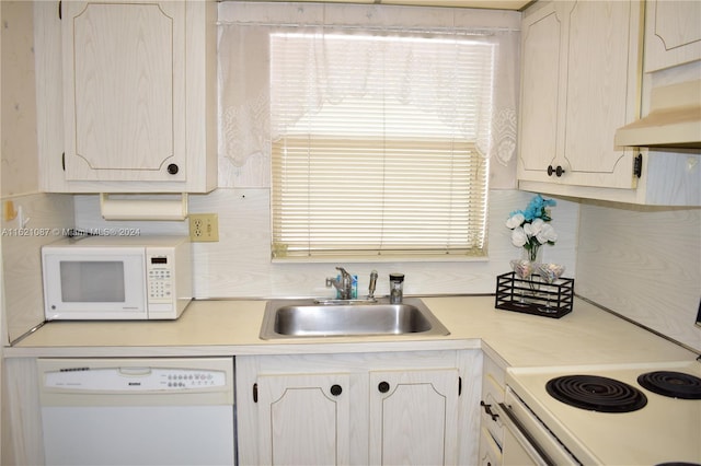 kitchen featuring sink, white appliances, and decorative backsplash