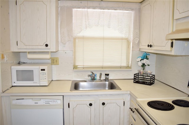 9621 Sunrise Lakes Blvd Unit 302, Sunrise, FL 33322 - kitchen featuring white appliances, white cabinetry, under cabinet range hood, light countertops, and a sink