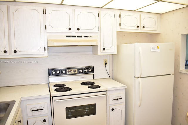 kitchen with white cabinets, white appliances, and sink