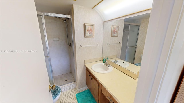 bathroom with tile patterned floors, a shower with shower door, and vanity