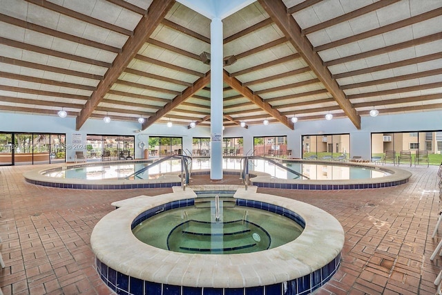 view of swimming pool with an indoor in ground hot tub and a patio