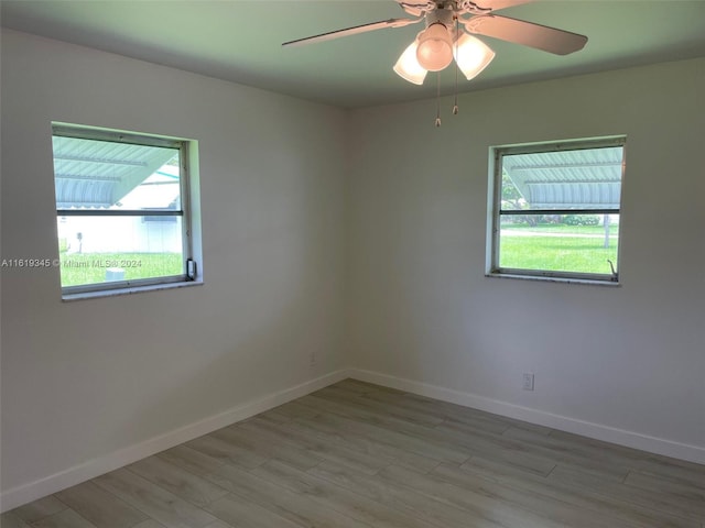 spare room featuring ceiling fan and light hardwood / wood-style flooring