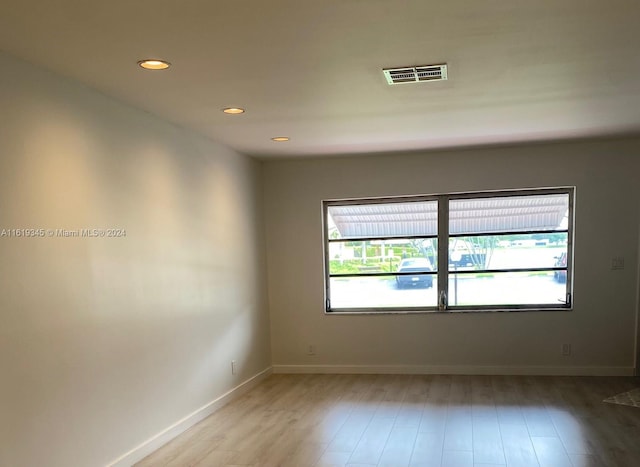 spare room with hardwood / wood-style flooring