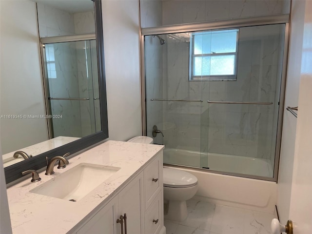 full bathroom featuring tile patterned flooring, toilet, shower / bath combination with glass door, and vanity