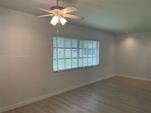 spare room featuring hardwood / wood-style flooring and ceiling fan