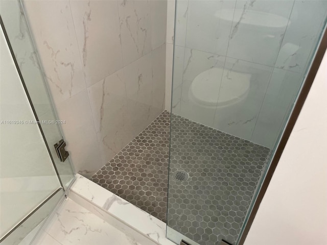 bathroom with tiled shower and toilet