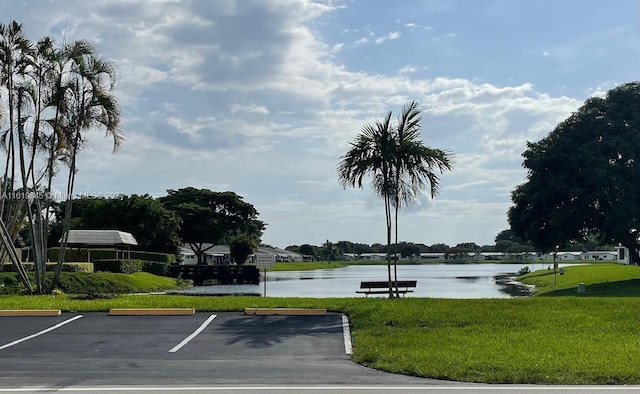 exterior space featuring a lawn and a water view