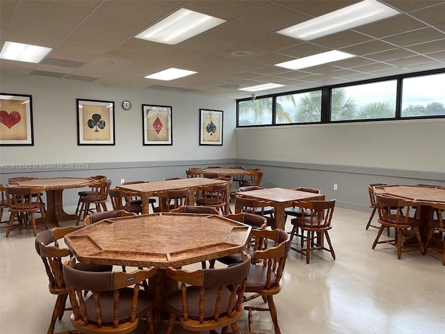 tiled dining space featuring plenty of natural light and a paneled ceiling